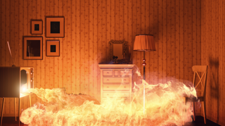 Symbolbild Vermieter-Hausratversicherung. Bild zeigt einen Brand in einem Wohnzimmer.